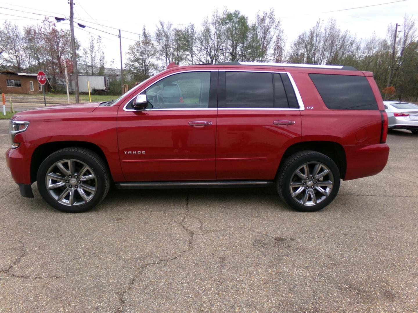 2015 Crystal Red Tintcoat /Tan Chevrolet Tahoe LTZ 4WD (1GNSKCKC1FR) with an 5.3L V8 OHV 16V engine, 6-Speed Automatic transmission, located at 401 First NE, Bearden, AR, 71720, (870) 687-3414, 33.726528, -92.611519 - Photo#1